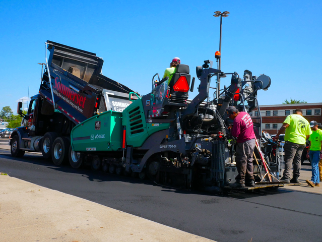 Paving crew resurfacing a government roadway in Michigan